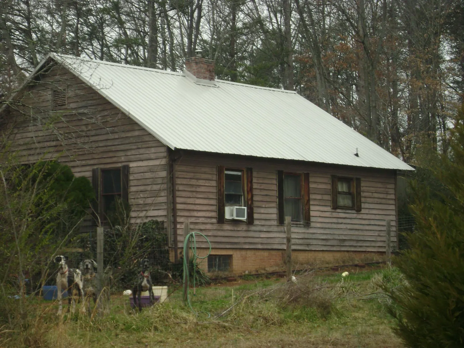 White metal roof on an old wood sided farmhouse, from a Asphalt Shingle Roof Repair job in New Goshen
